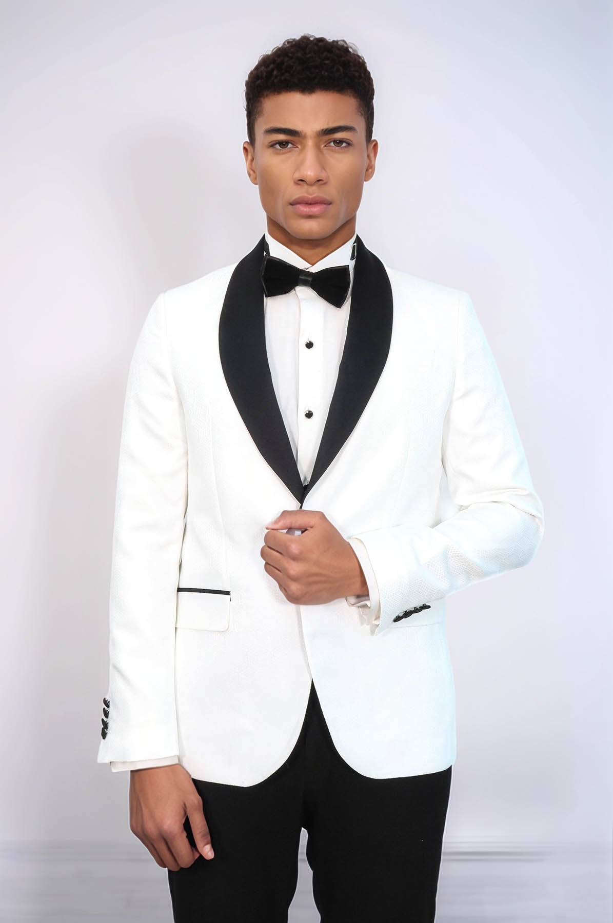 white suit with black bow tie